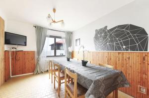 a dining room with a table and chairs at Horská chata NATURA Nové Město in Nové Město