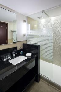 a bathroom with a sink and a shower at Saja Al Madinah in Al Madinah