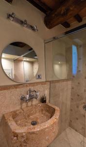 a bathroom with a stone sink and a mirror at Casolare Marconi in Panicale +38 photos