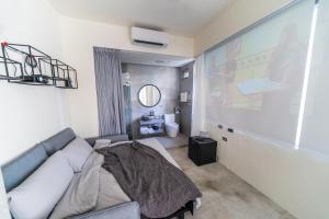 a living room with a couch and a large screen at Dagan B&B in Kaohsiung