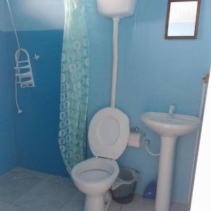 łazienka z toaletą i umywalką w obiekcie Residencial Água Azul w mieście Capão da Canoa