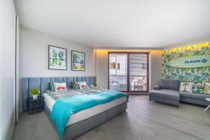 a bedroom with a large bed and a couch at Surf Apart in Władysławowo