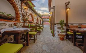 a restaurant with tables and chairs in a room at Vezyuva House in Bansko