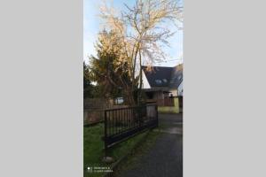 a house with a gate in front of a yard at Appartement chaleureux in Haguenau