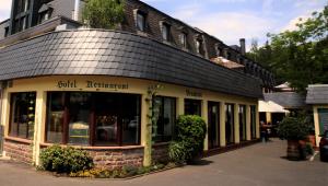 a building with a black roof on a street at Blesius Garten in Trier