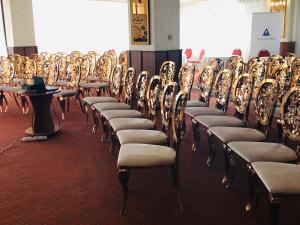 a row of chairs lined up in a room at Hotel Plaza in Craiova