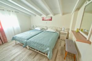 a bedroom with a bed and a chair in it at Villa Tesoro in Agios Georgios