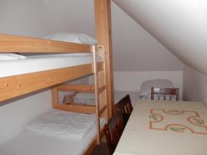a room with two bunk beds and a table at Ubytování Verner in Deštné v Orlických horách