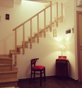 a stairway with a chair and a table and a lamp at Appartamento PANTA REI 2 in Mola di Bari