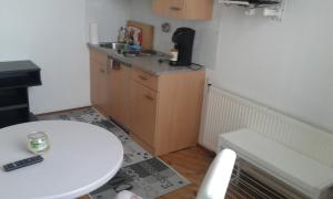 a small kitchen with a table and a sink at Ferienwohnung - Apartement - Hotel Klippitz Nordost in Reichenfels