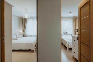 Postel nebo postele na pokoji v ubytování Lina apartamenti
