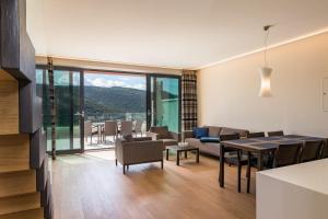 a living room with a table and chairs and a view at Park Hill Residences in Rabac