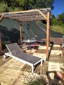 a wooden deck with a table and a pergola at La perle du 58 - T2 Parking Wifi Terrasse CLIM in Rodez