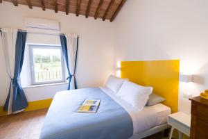 A bed or beds in a room at Tenuta La Santissima