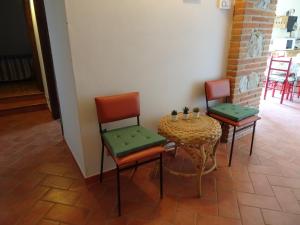 a table and two chairs and a table with a table and chairs at Lucignolo in Lucignano