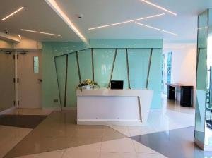 a room with a white counter in a room with green walls at City Center Residence in Pattaya Central +16 photos