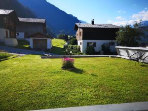 a yard with a house and a field of grass at Ferienhaus Lerch in Sankt Gallenkirch +10 photos