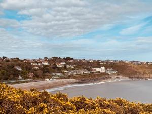 a view of a beach with houses and condos at The Coast House in The Mumbles