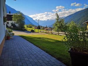 a brick walkway with mountains in the background at Ferienhaus Lerch in Sankt Gallenkirch