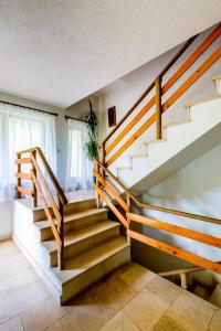 a staircase in a house with wooden railings at Pensiunea Armonia in Nădăşelu