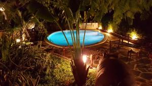 una gran piscina por la noche con luces en Boutique Hotel Nyumbani Tembo, en Watamu