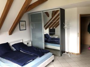 a bedroom with a large glass cabinet with two beds at Ferienwohnung Tetto Piccolo in Bad Säckingen