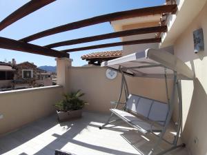 a chair on the balcony of a house at Hotel Regina Simius in Villasimius