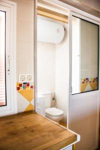 a bathroom with a toilet and a window at Una ventana al mar in Rota +27 photos