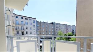 an apartment balcony with a view of buildings at Apartament Batory in Gdynia