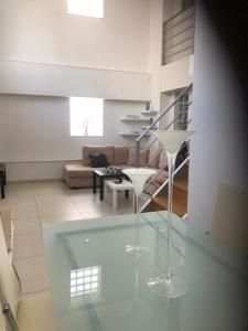 two clear glasses on a glass table in a living room at Maisonette Lux Modern Next to Metro Kerameikos 3 Rooms in Athens