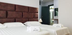 Postel nebo postele na pokoji v ubytování Asi Rooftop Hotel