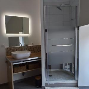 a glass shower in a bathroom with a sink at Le Cottage de L Abbaye in Lonlay-lʼAbbaye +49 photos