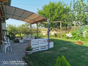 a backyard with a pergola and a table and bench at Bed And Breakfast "ANNA" in Bagnara Calabra