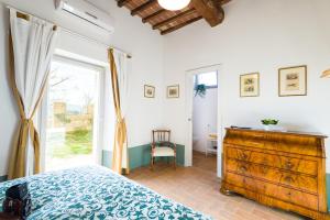 A bed or beds in a room at Tenuta La Santissima