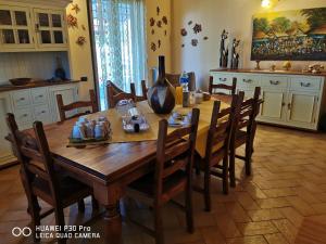 a wooden table in a kitchen with chairs around it at Bed And Breakfast "ANNA" in Bagnara Calabra