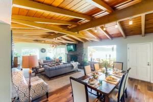 a living room with a wooden ceiling and a table at Waterfront Getaway in Poulsbo