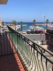 a balcony with a view of a street and a harbor at F2 + GARAGE RESIDENCE FRONT DE MER in Banyuls-sur-Mer