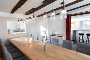 a dining room with a wooden table and chairs at Ferienhaus Olive Tree in Bullay