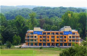 a large building in the middle of a field at Solei Apartments in Primorsko