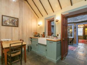 a kitchen with a sink and a counter top at The Precinct House in Newton Stewart