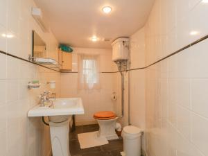 a bathroom with a toilet and a sink at The Precinct House in Newton Stewart