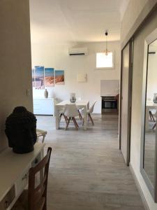 a living room with a table and chairs in it at F2 + GARAGE RESIDENCE FRONT DE MER in Banyuls-sur-Mer