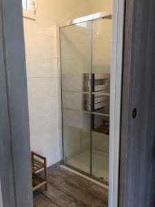 uma porta de duche em vidro com uma cadeira num quarto em F2 + GARAGE RESIDENCE FRONT DE MER em Banyuls-sur-Mer