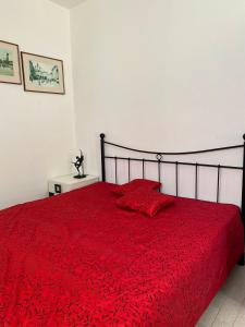 a bedroom with a red bed with a red blanket at Anči in Pula