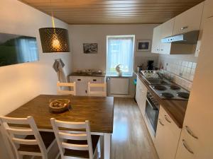 a kitchen with a wooden table and a dining room at Apartment 003 Kassel Harleshausen in Kassel