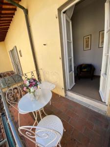 una mesa y sillas con un jarrón de flores en el patio en B&B Residenza San Gallo 79, en Florencia