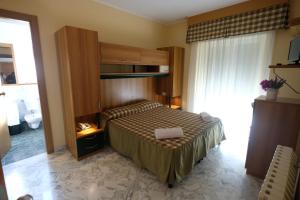 a hotel room with a bed and a bathroom at Hotel B&B Pescofalcone in Caramanico Terme