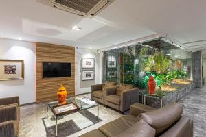 ein Wohnzimmer mit einem Sofa und einem Aquarium in der Unterkunft Hotel Bahia do Sol in Salvador