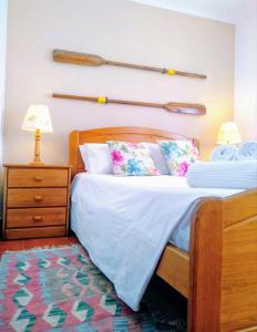 a bedroom with a bed with two baseball bats on the wall at Casa Azul in Óbidos