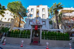 a white building with orange cones in front of it at City Hotel Marmaris in Marmaris